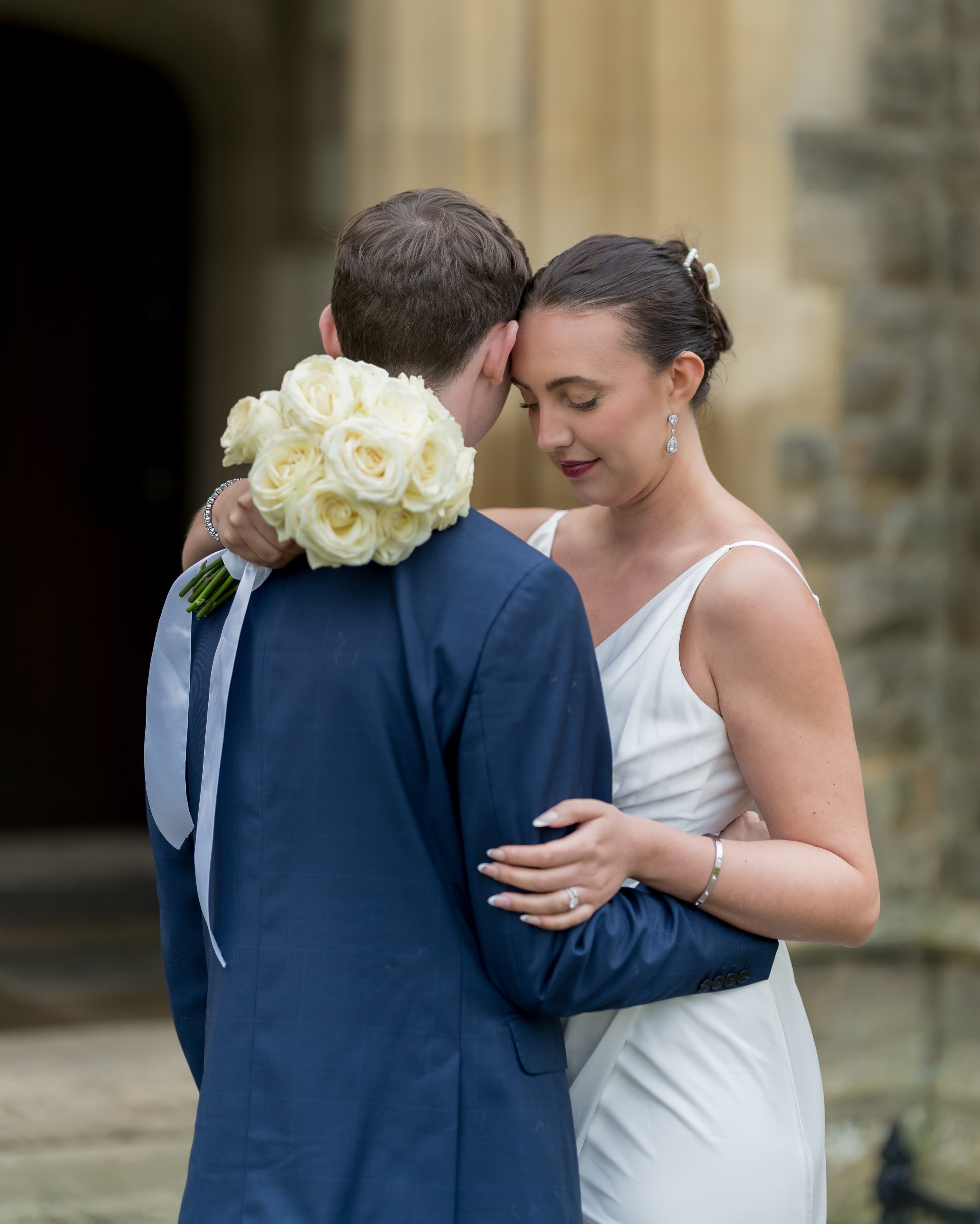 Wedding couple embracing in joyful celebration with documentary photography style