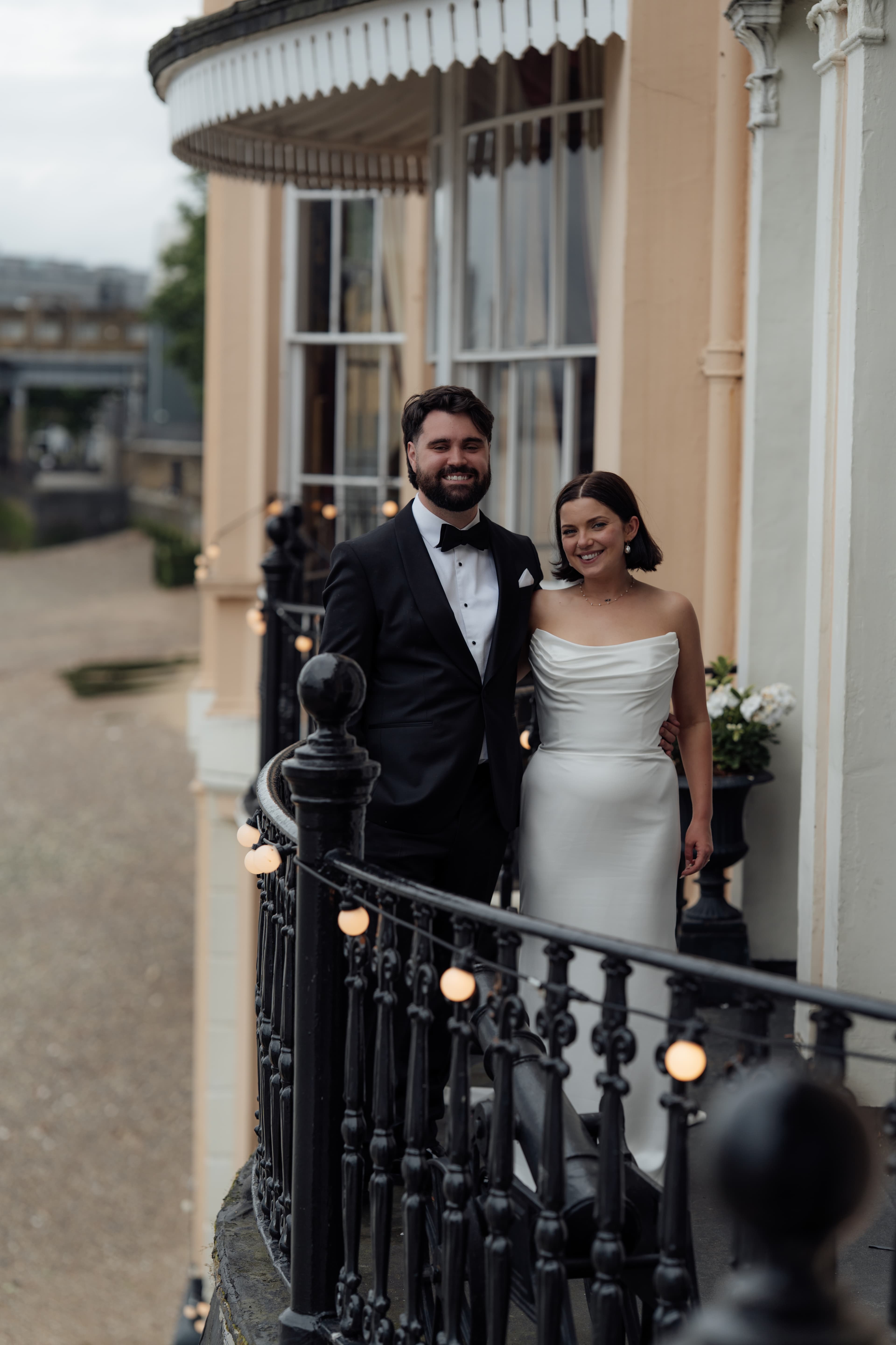 Bride and groom Kirsty and Jamie sharing a romantic moment on a balcony