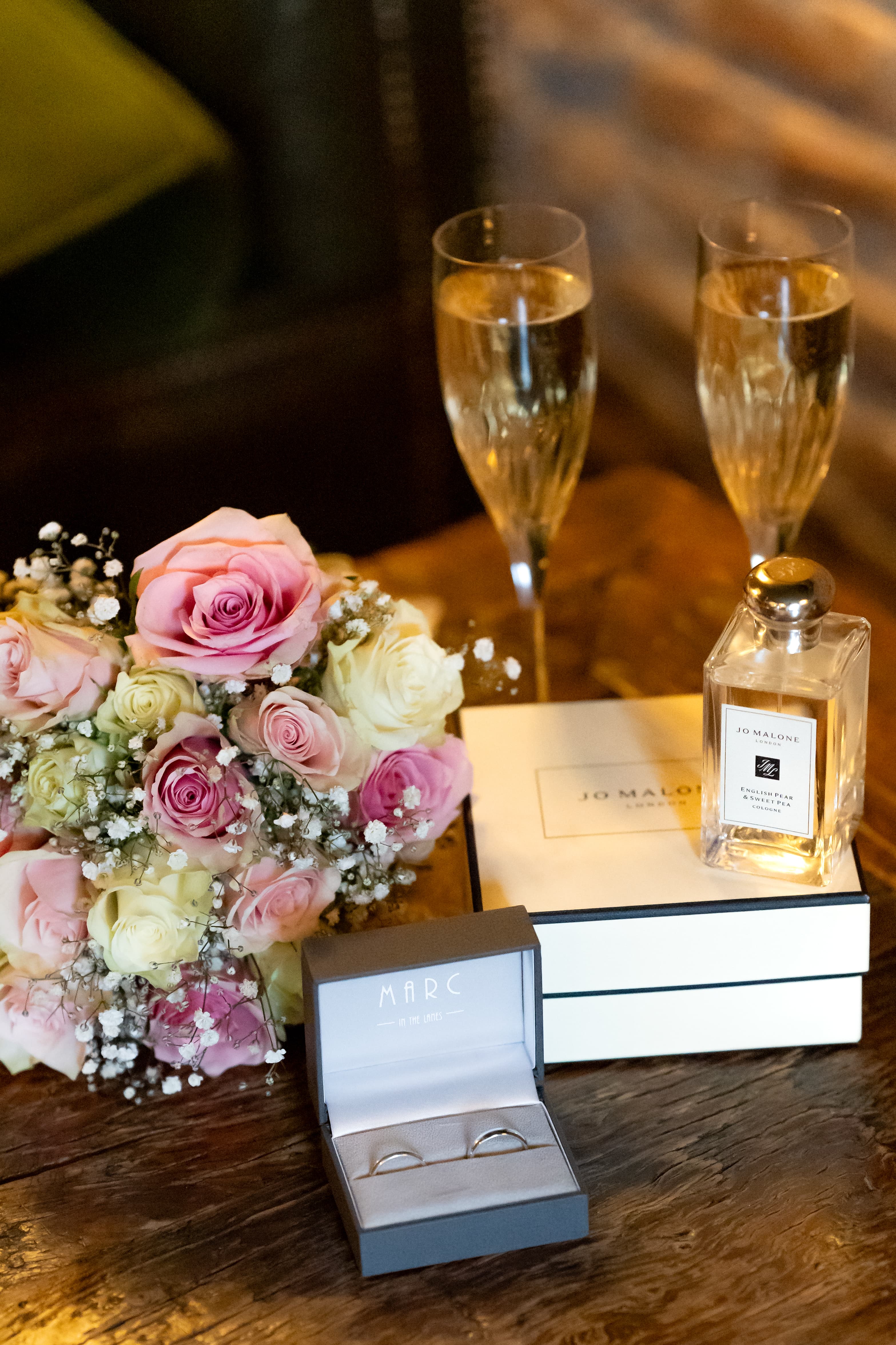 Elegant wedding still life arrangement featuring flowers and wedding details