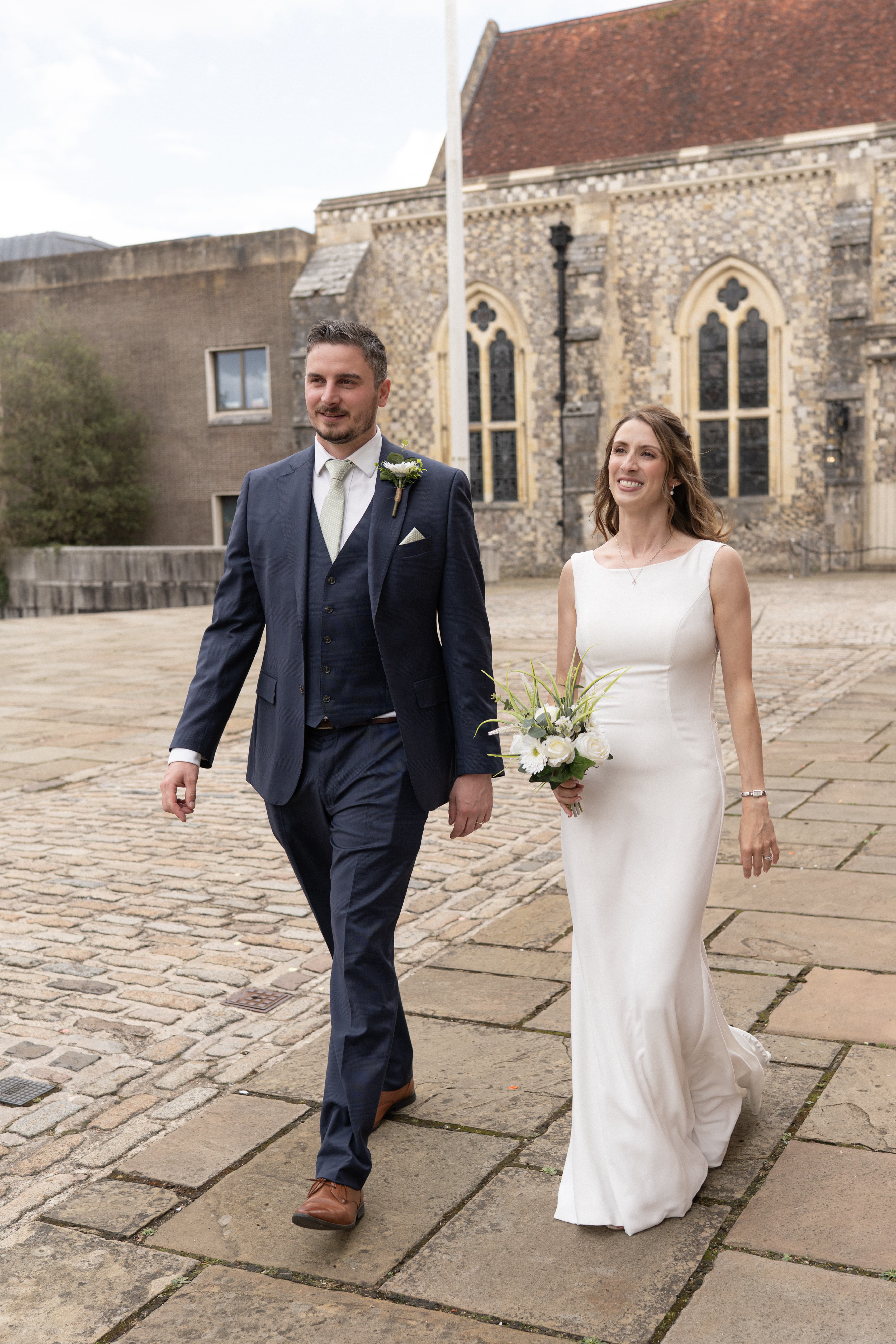 Bride and groom Nikki and Chris walking hand in hand during their wedding day